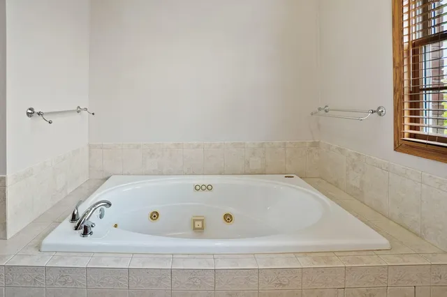 a bed room with a bed and a large window