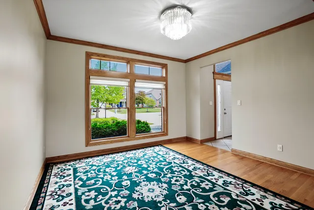 a kitchen with stainless steel appliances granite countertop a sink a stove a dining table and chairs