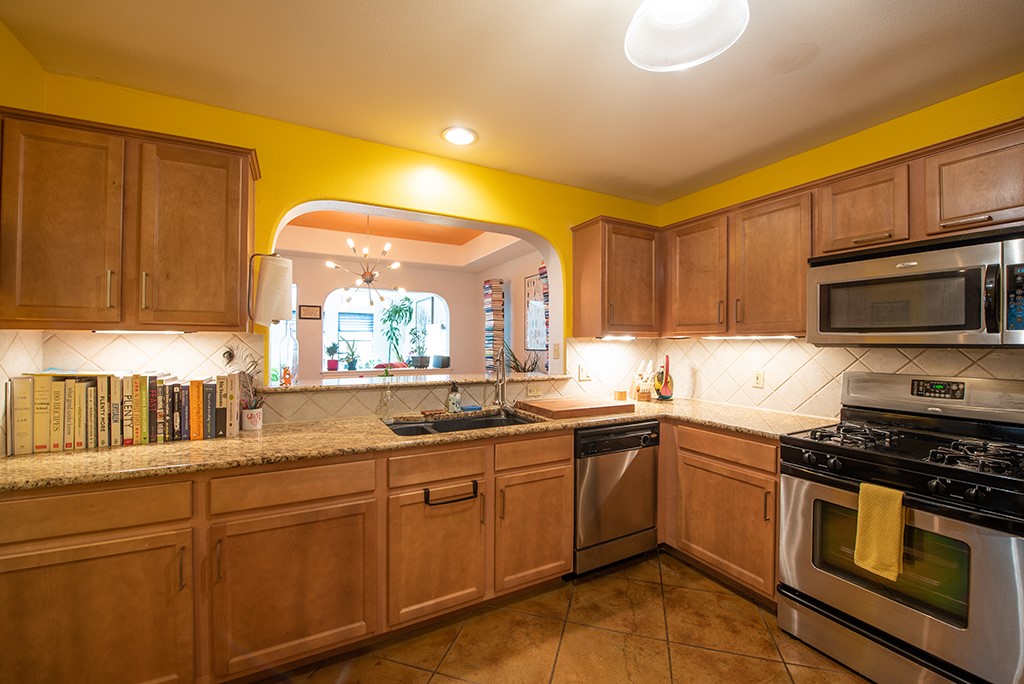 3609 Clawson Road, Unit A Austin, TX 78704 - Photo 4 of 17 A well-equipped kitchen boasts durable granite counters, ample wood cabinetry, and stainless steel appliances.