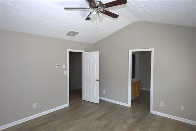 a view of an empty room with a ceiling fan