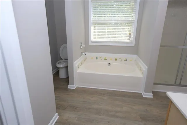 a bathroom with a bathtub and a window