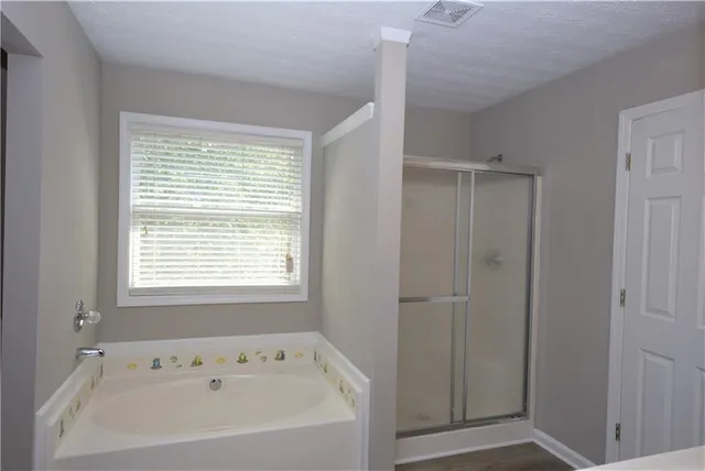a bathroom with a bathtub and shower