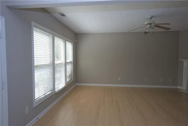 wooden floor in an empty room with a window