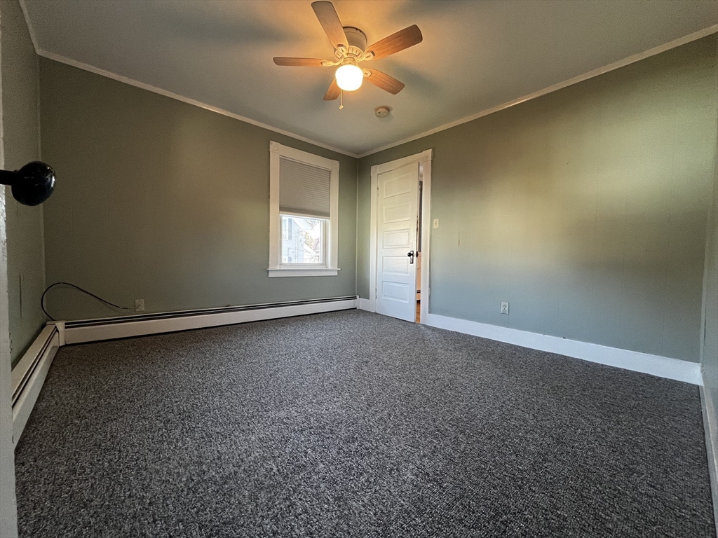 263 Middlesex Street, Unit 2 North Andover, MA 01845 - Photo 12 of 16 an empty room with windows and fan