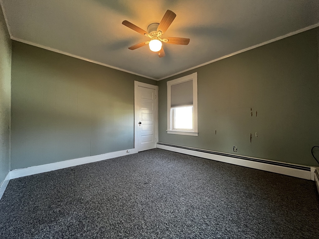 263 Middlesex Street, Unit 2 North Andover, MA 01845 - Photo 13 of 16 an empty room with a chandelier fan and windows