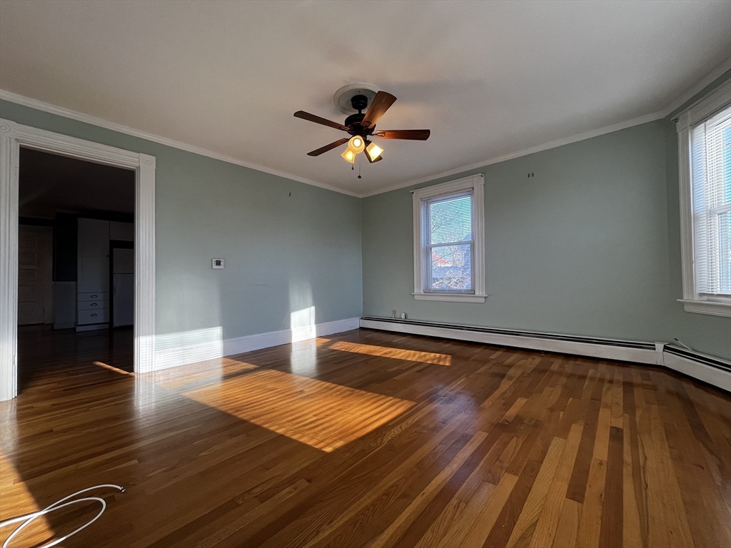 263 Middlesex Street, Unit 2 North Andover, MA 01845 - Photo 3 of 16 a bedroom with natural light and hardwood floor