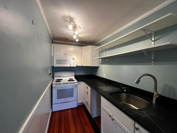a kitchen that has a sink and cabinets