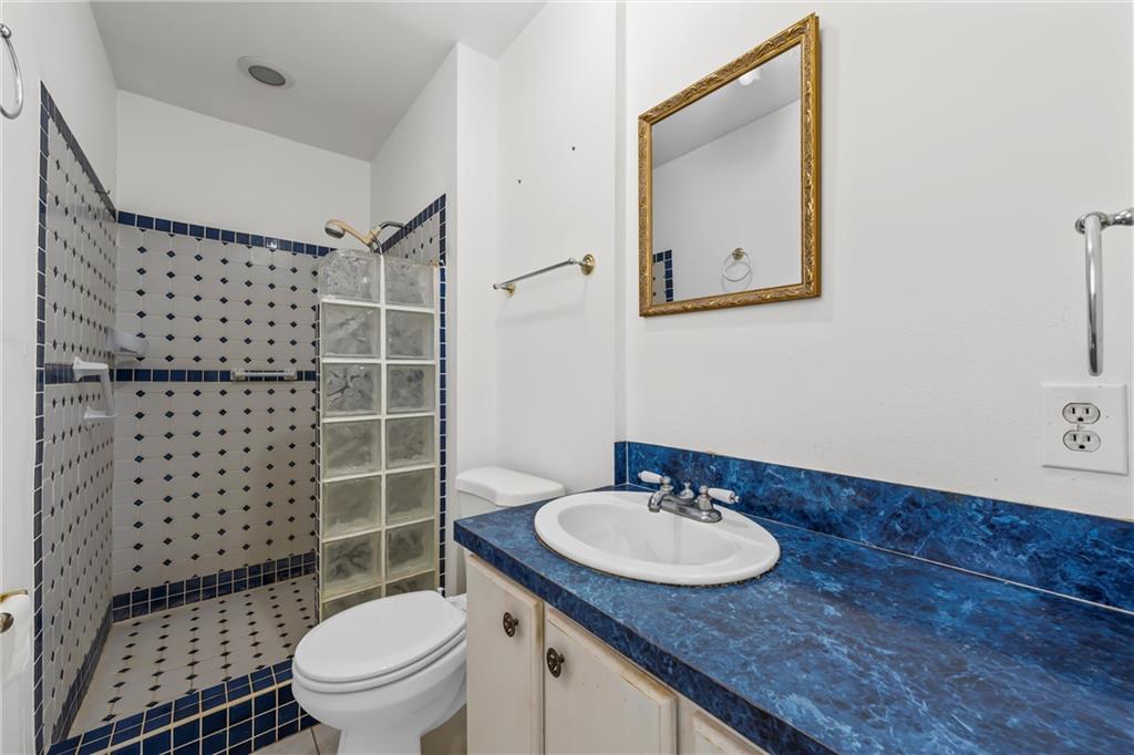 271 Candyce Drive Lorena, TX 76655 - Photo 16 of 27 a bathroom with a sink toilet vanity and shower