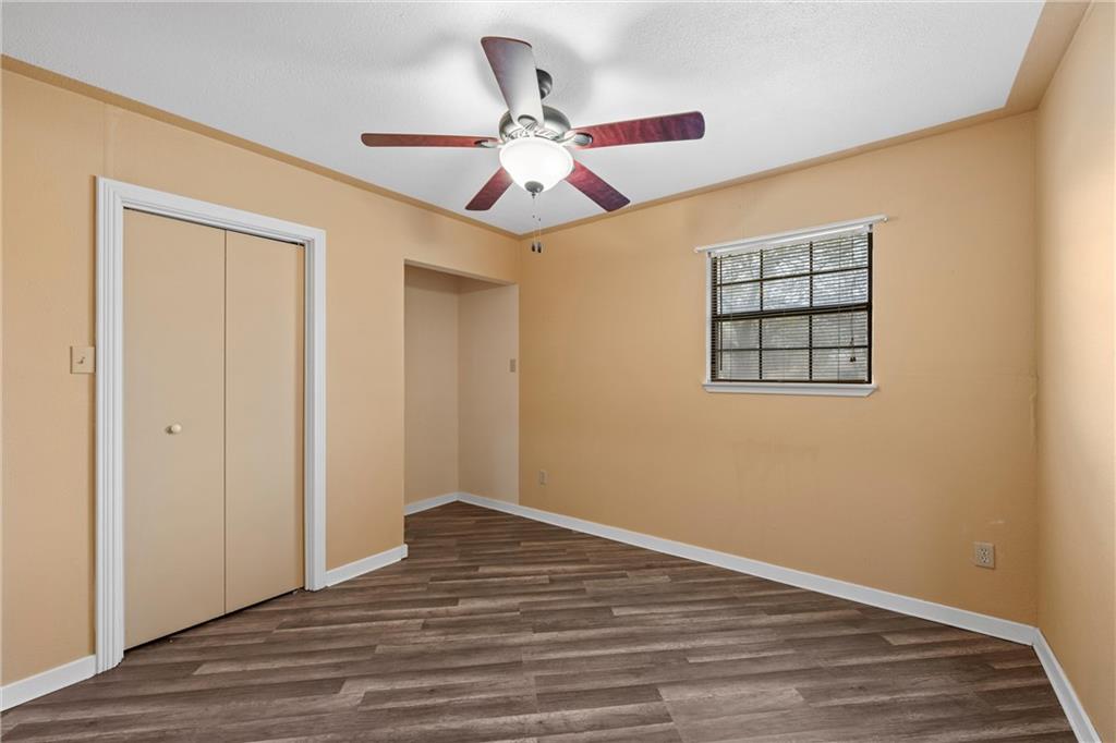 271 Candyce Drive Lorena, TX 76655 - Photo 17 of 27 a view of an empty room with wooden floor and a ceiling fan