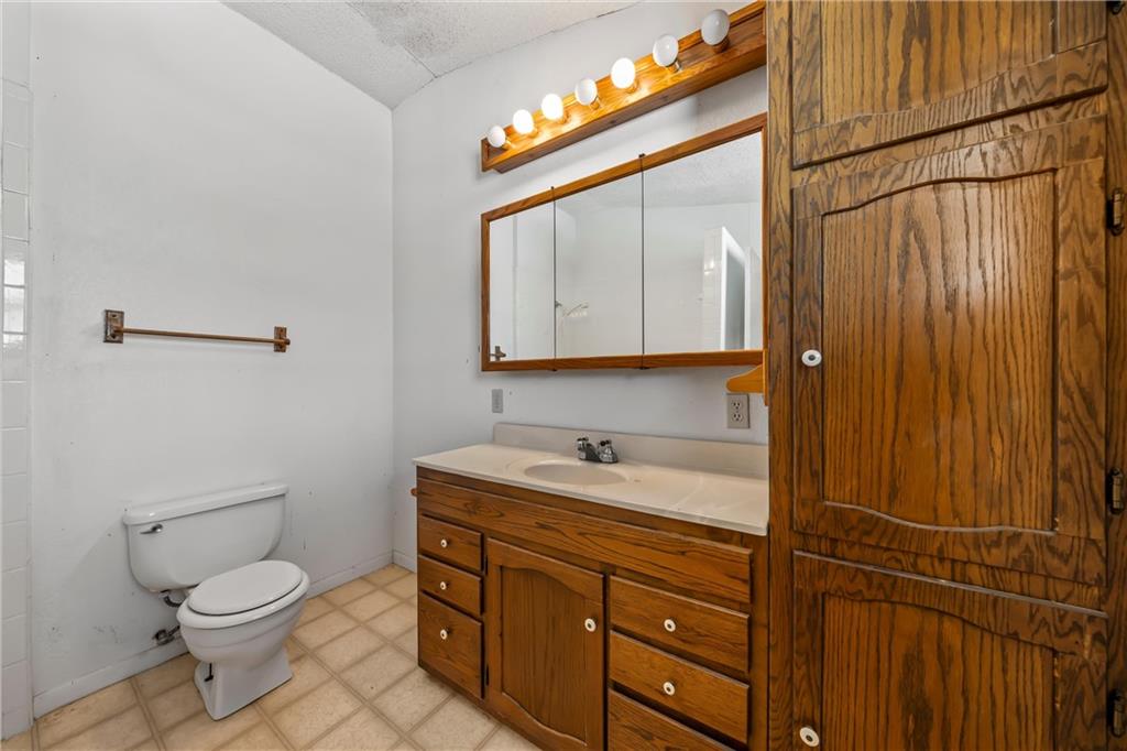 271 Candyce Drive Lorena, TX 76655 - Photo 21 of 27 a bathroom with a toilet sink vanity and mirror