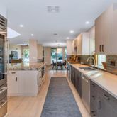 a large kitchen with stainless steel appliances and a large window