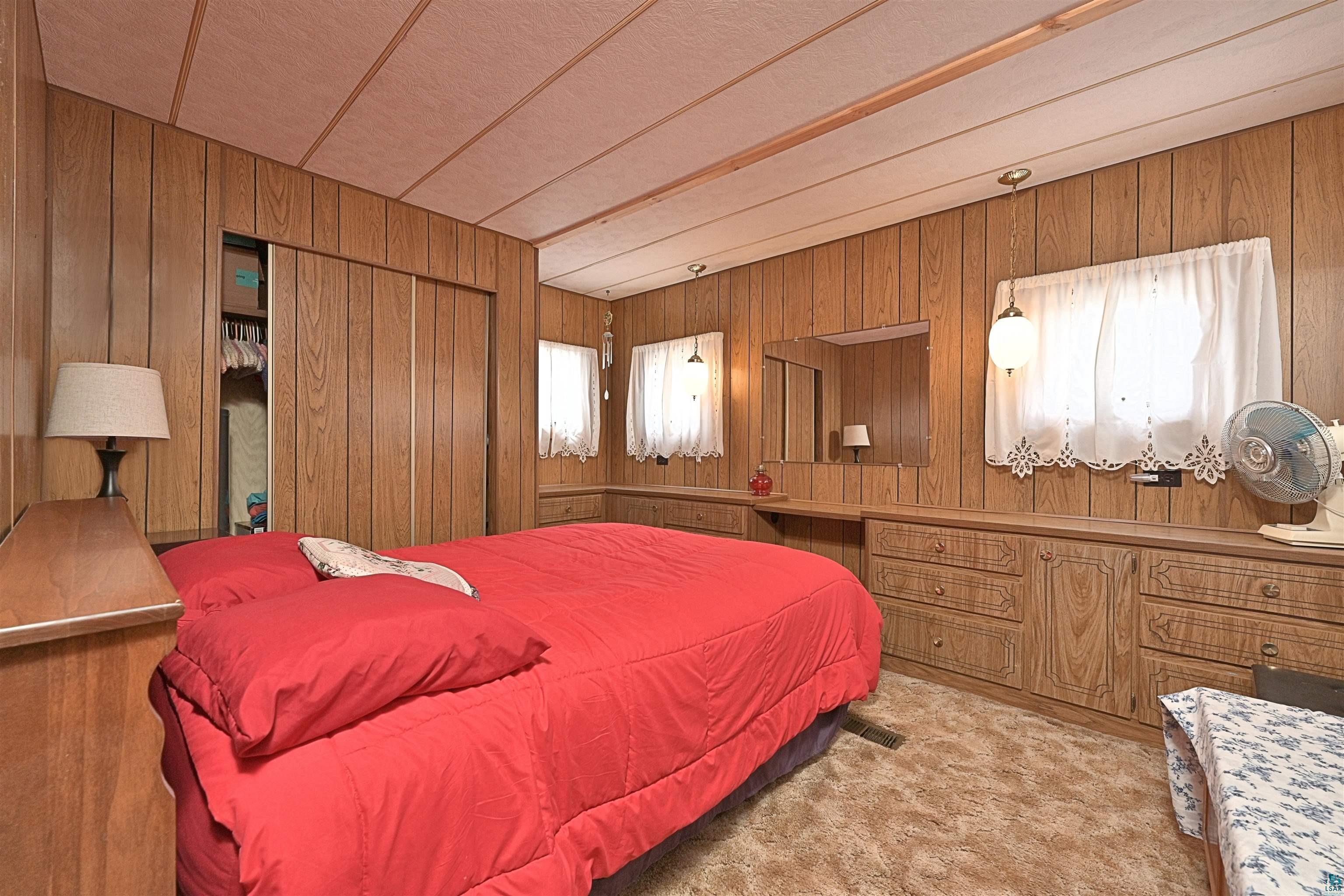 6800 Salveson Road Finland, MN 55603 - Photo 15 of 20 Bedroom with wooden walls, carpet, and multiple windows
