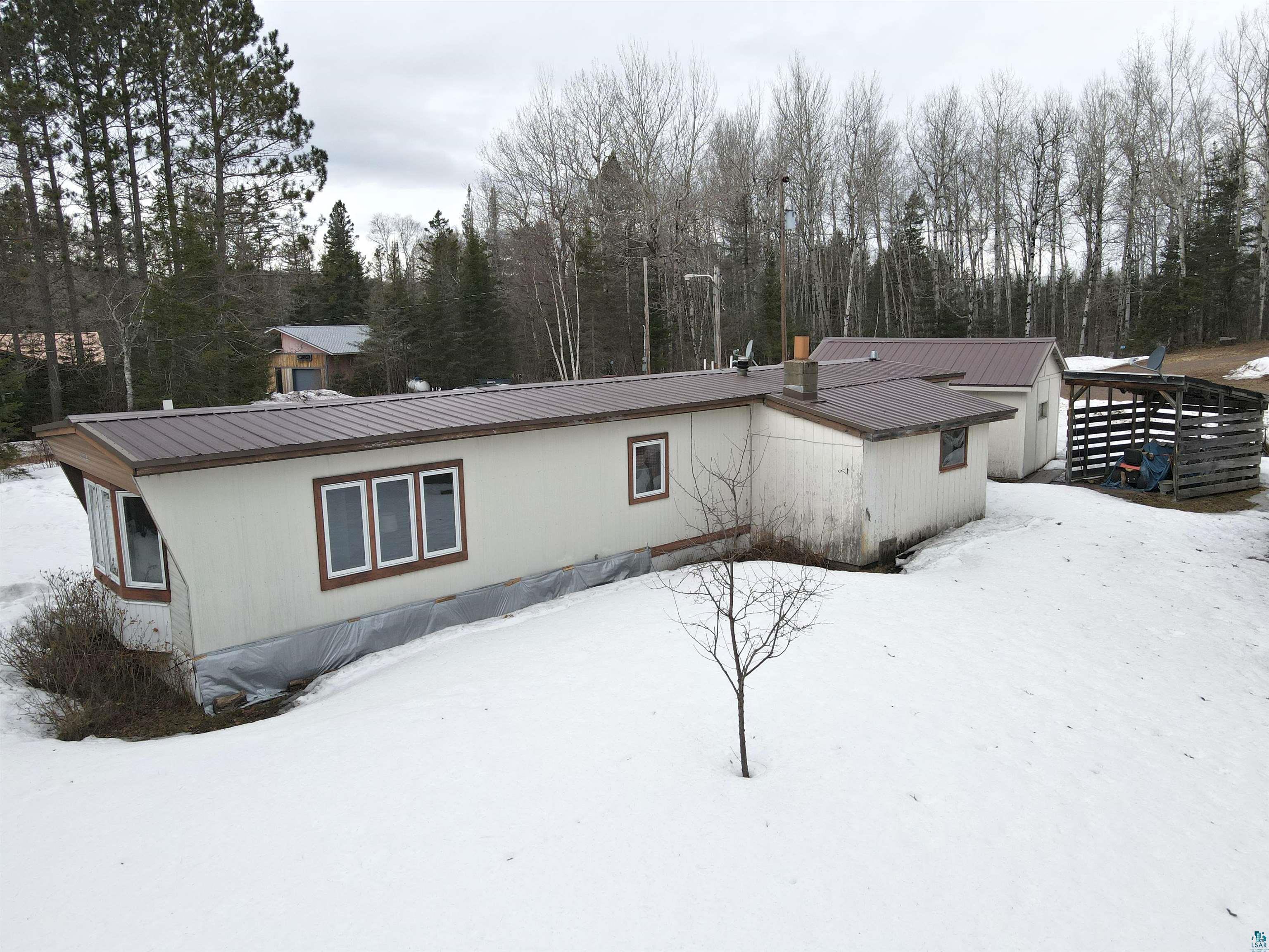 6800 Salveson Road Finland, MN 55603 - Photo 7 of 20 Snow covered back of property featuring a metal roof