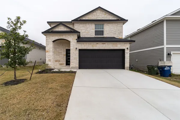 a front view of a house with yard