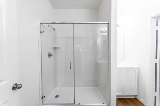 a bathroom with a glass shower door
