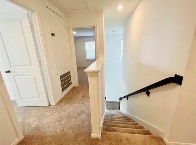 a view of a livingroom with wooden floor and stairs