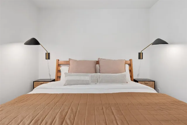 a bedroom with a bed and a night stand