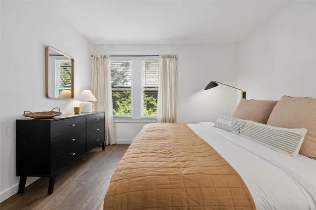 a spacious bedroom with a large bed and a window