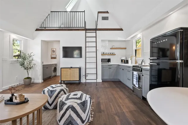 a living room with furniture and flat screen tv