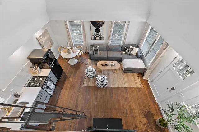 a view of living room with furniture and wooden floor