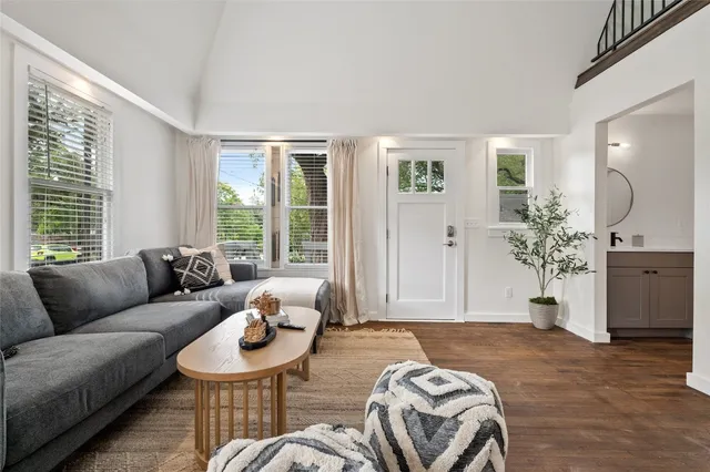 a bedroom with furniture and a large window