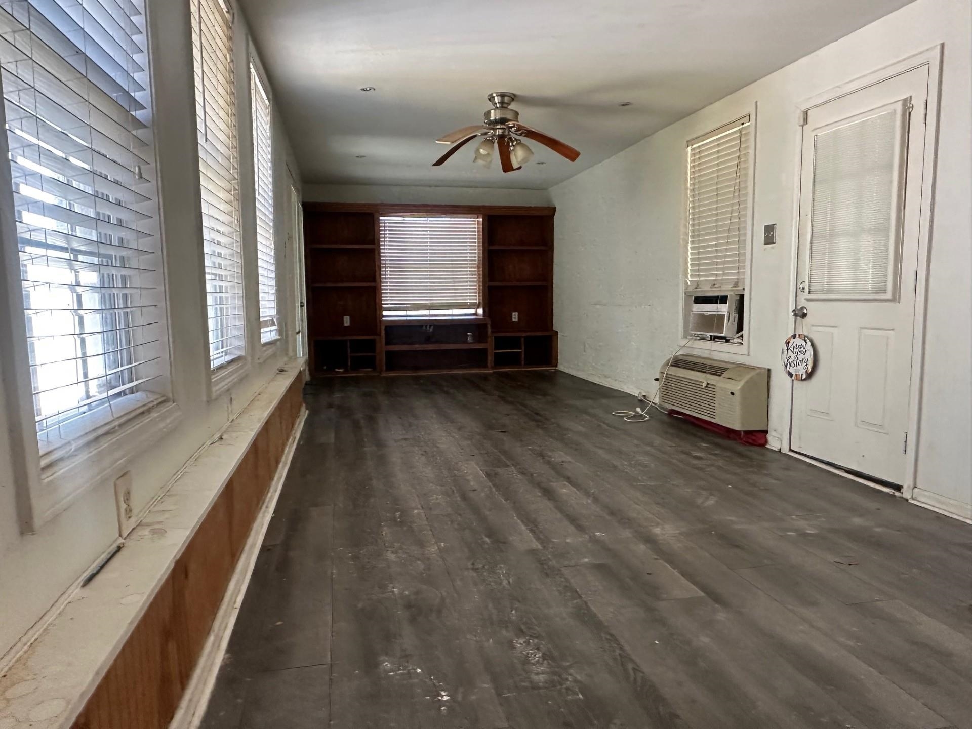 3628 Carrington Road Memphis, TN 38111 - Photo 5 of 15 Unfurnished living room featuring dark wood-style floors, a ceiling fan, and cooling unit