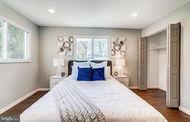 a bedroom with a large bed and a window