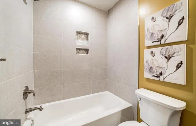 a white bath tub sitting next to a white toilet