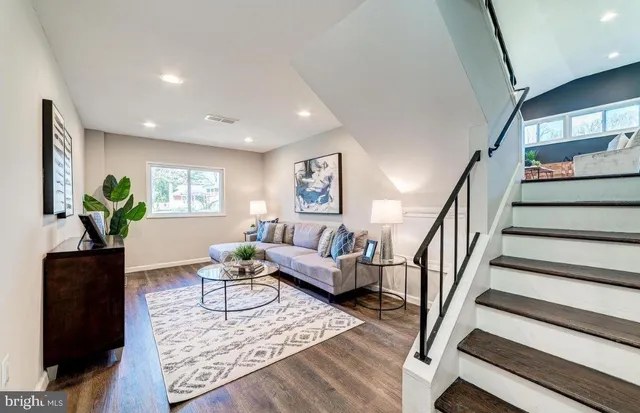 a living room with furniture and a potted plant