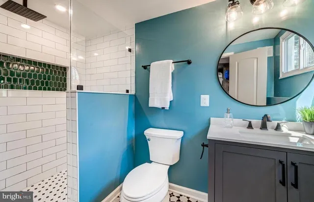a bathroom with a toilet a sink and mirror