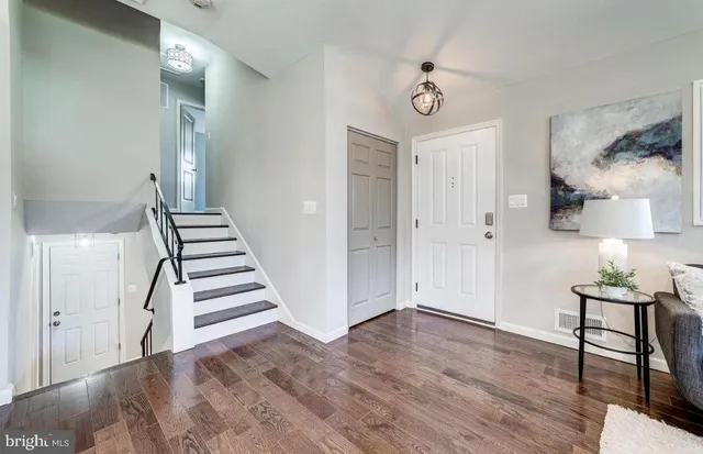 a view of a room with wooden floor and white walls