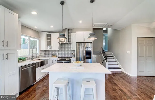 a kitchen with stainless steel appliances kitchen island a large island in the center