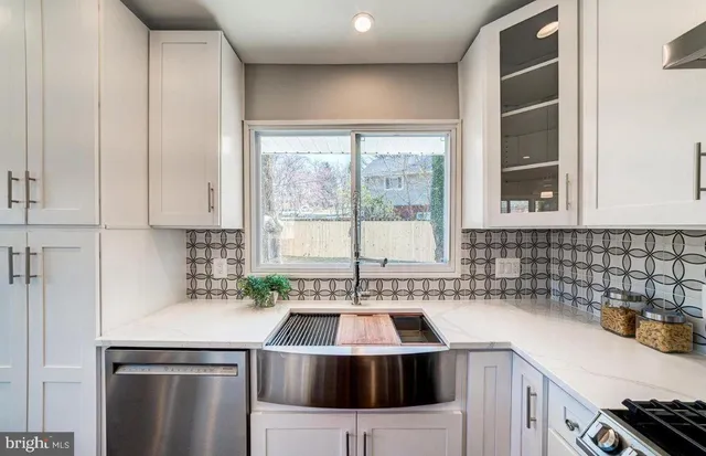 a kitchen with a sink a stove and cabinets