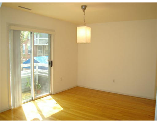 8 Chestnut Street, Unit 8 Cambridge, MA 02139 - Photo 6 of 11 a view of empty room with wooden floor and fan
