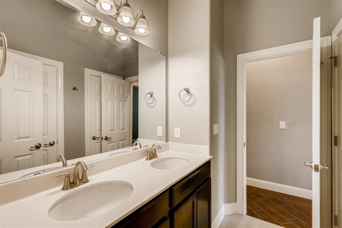 6108 Sabino Drive Spicewood, TX 78669 - Photo 17 of 22 a bathroom with a sink double vanity granite tub and shower