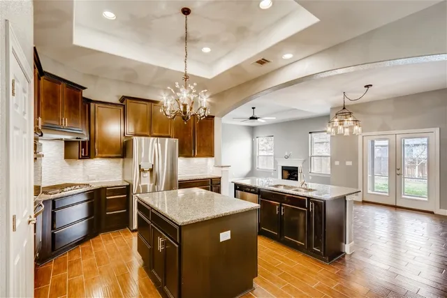 a kitchen with stainless steel appliances granite countertop a stove and a refrigerator