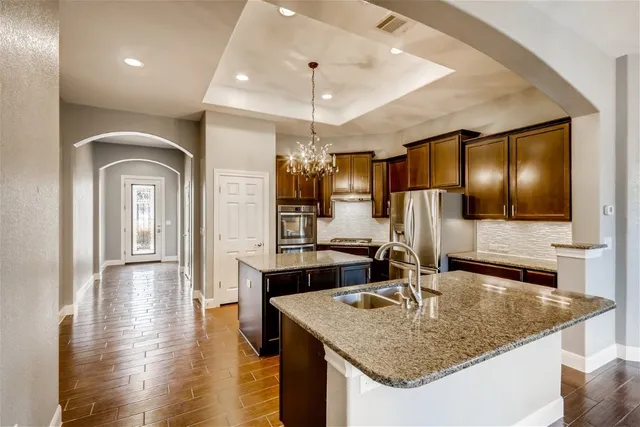 a kitchen with stainless steel appliances granite countertop a sink and cabinets
