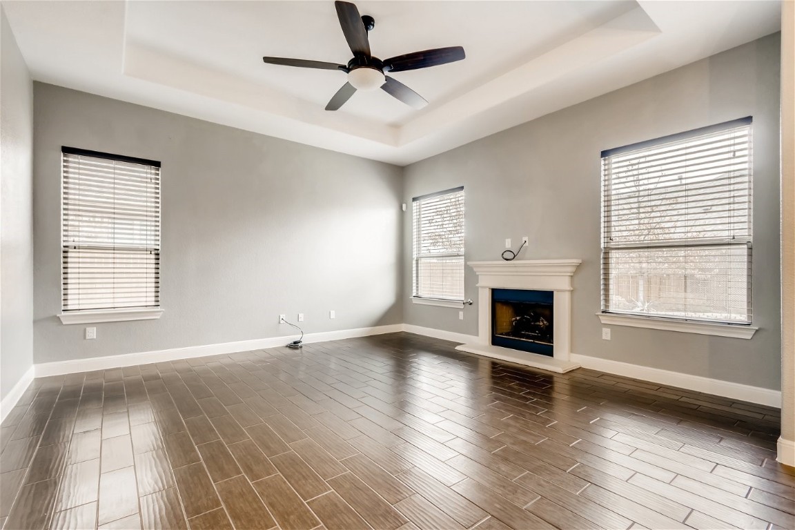 6108 Sabino Drive Spicewood, TX 78669 - Photo 8 of 22 a view of empty room with fireplace and wooden floor