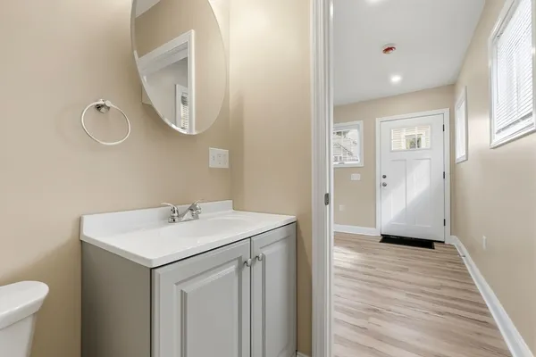 a bathroom with a sink a toilet and a mirror