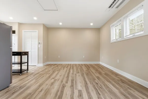 a view of room with window and wooden floor