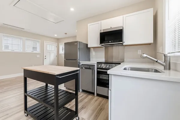 a kitchen that has a stainless steel appliances a sink and a counter