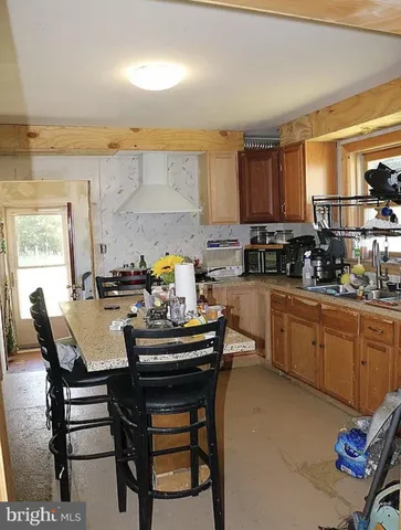 a kitchen with a sink a stove and chairs