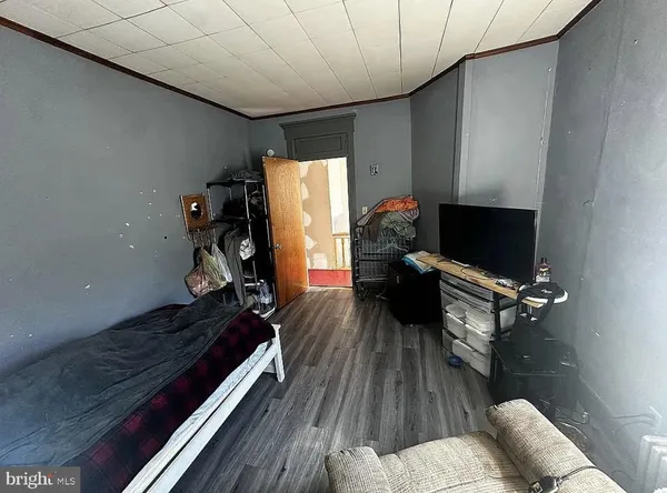 a view of a room with wooden floor and furniture