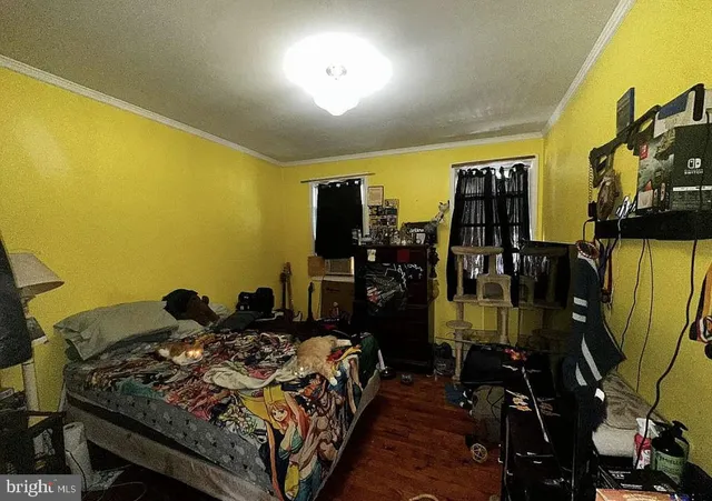 a bed sitting in a bedroom next to a window