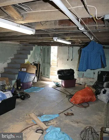 a living room with furniture and a air conditioner vent
