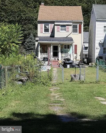 a view of a house with a yard porch and sitting area