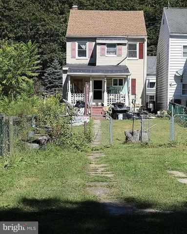 a view of a house with a yard porch and sitting area