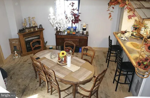 a view of a dining room with furniture and chandelier