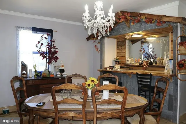 a view of a dining room with furniture and chandelier