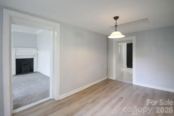 wooden floor in an empty room with a mirror